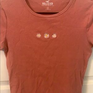 This is an older style from Hollister. It has a wavy bottom edge.